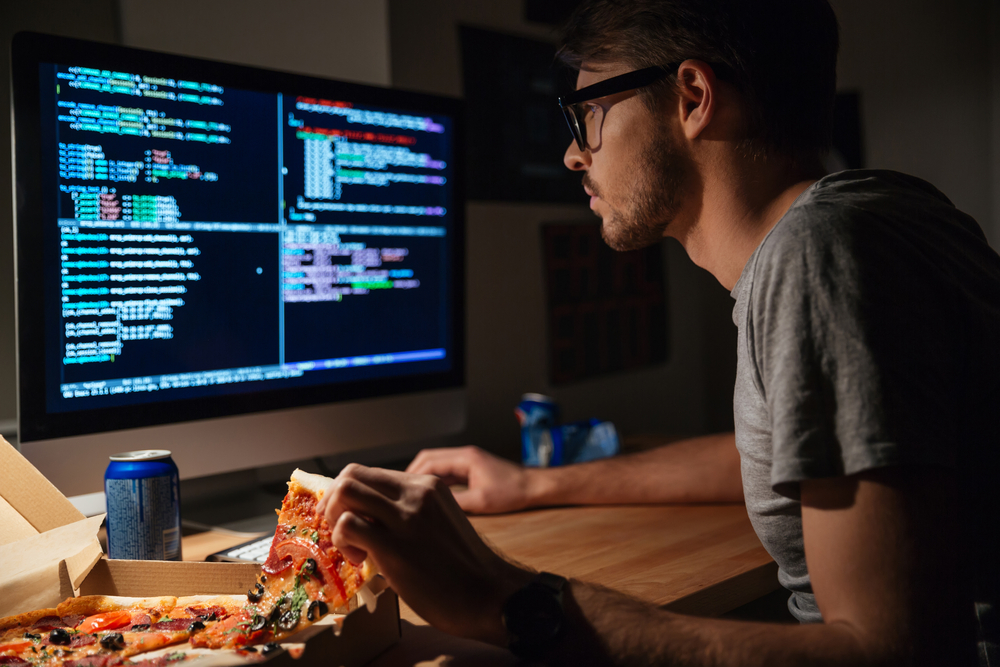 Profile,Of,Concentrated,Young,Software,Developer,Eating,Pizza,And,Coding