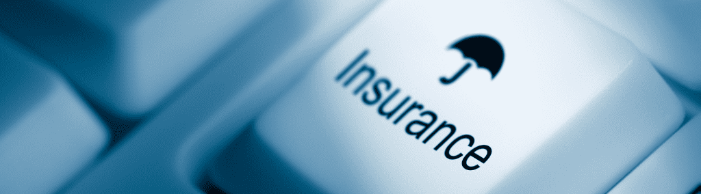 Close up of a computer keyboard key with the word insurance with an umbrella