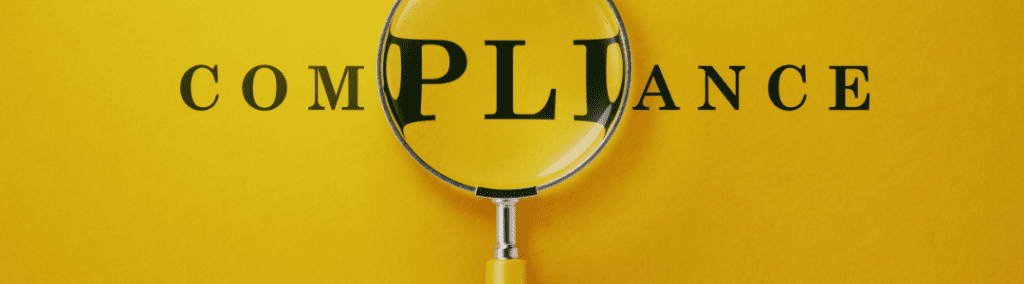 A magnifying glass over the text COMPLIANCE