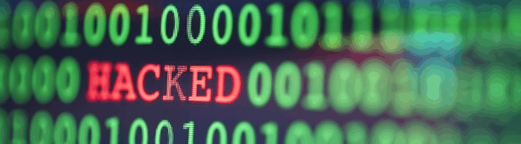 Close up of green computer text with hacked in red in the middle