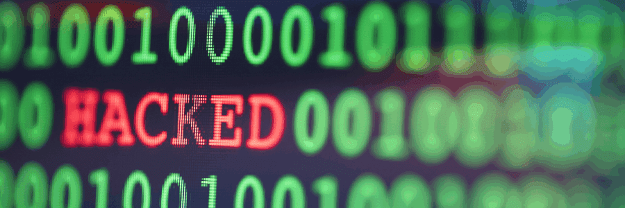 Close up of green computer text with hacked in red in the middle